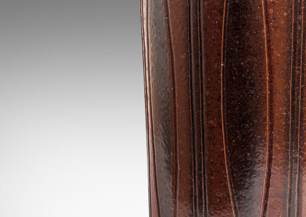 Gallery BAC cylindrical forms on floating reveals, with carved geometric patterns