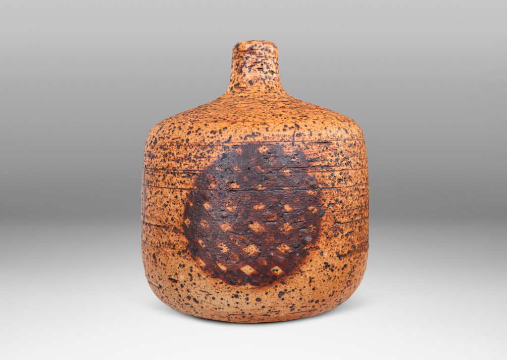Gallery BAC low cylindrical form with sprouting neck, with wiped brown glaze accentuating grog texture and brown grided circular forms