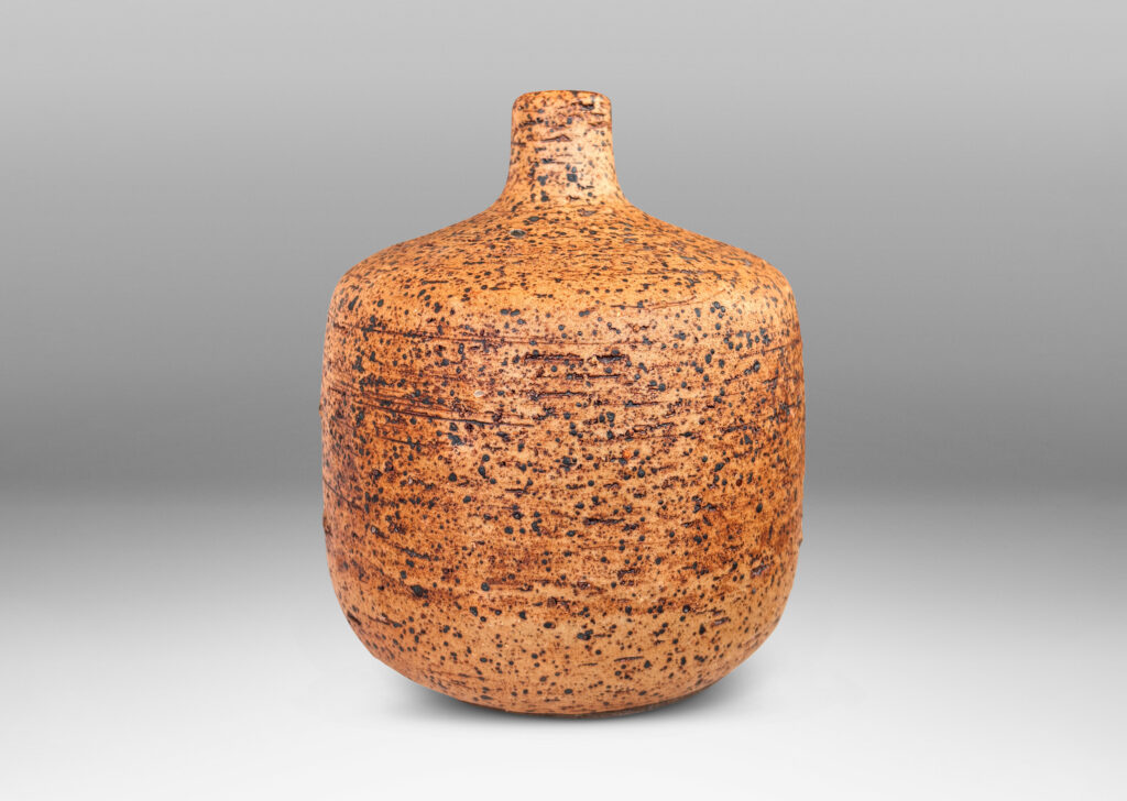 Gallery BAC low cylindrical form with sprouting neck, with wiped brown glaze accentuating grog texture and brown grided circular forms