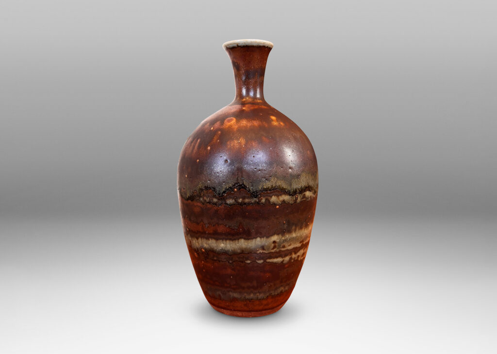 Gallery BAC tapered form with trumpeting neck, glazed in flowing brown luster, with hints of light taupe