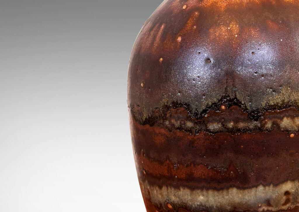 Gallery BAC tapered form with trumpeting neck, glazed in flowing brown luster, with hints of light taupe