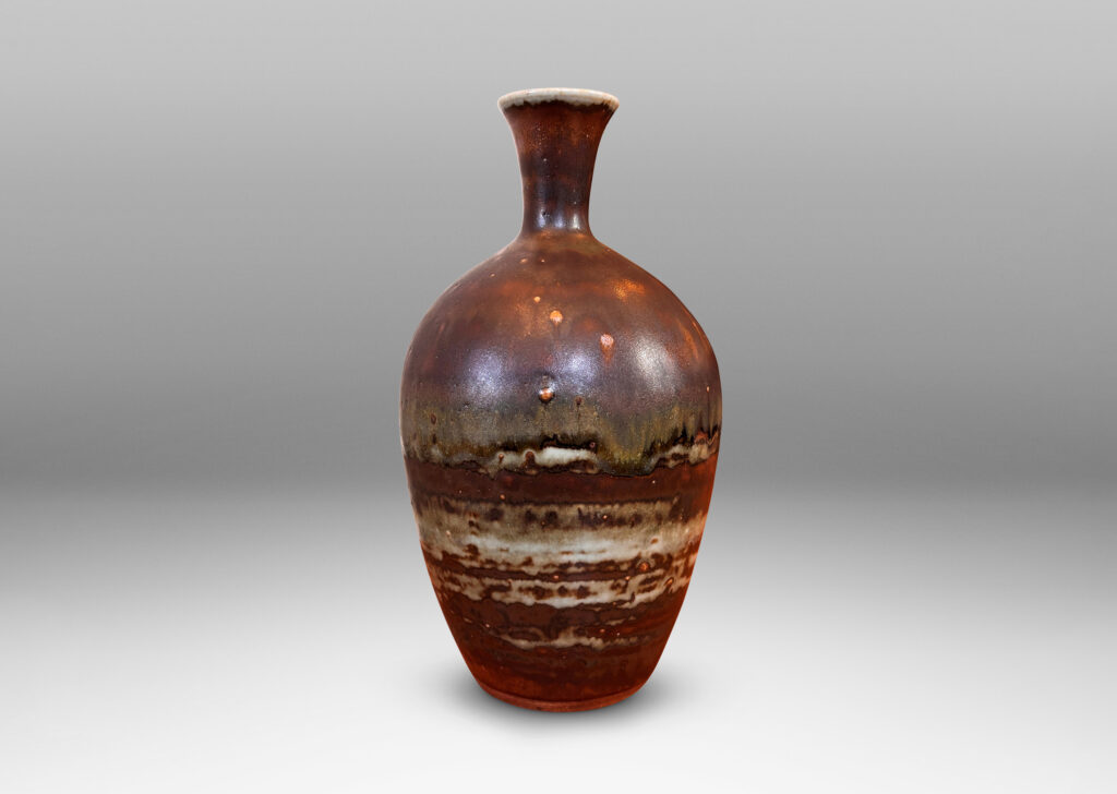 Gallery BAC tapered form with trumpeting neck, glazed in flowing brown luster, with hints of light taupe