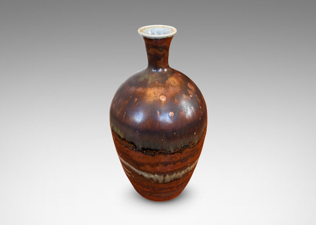Gallery BAC tapered form with trumpeting neck, glazed in flowing brown luster, with hints of light taupe