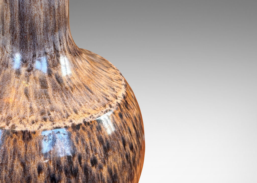 Gallery BAC plump globe form with sprouting neck and caoved shoulders, glazed in a tortoise shell evoking semi-shine mottled black over tan