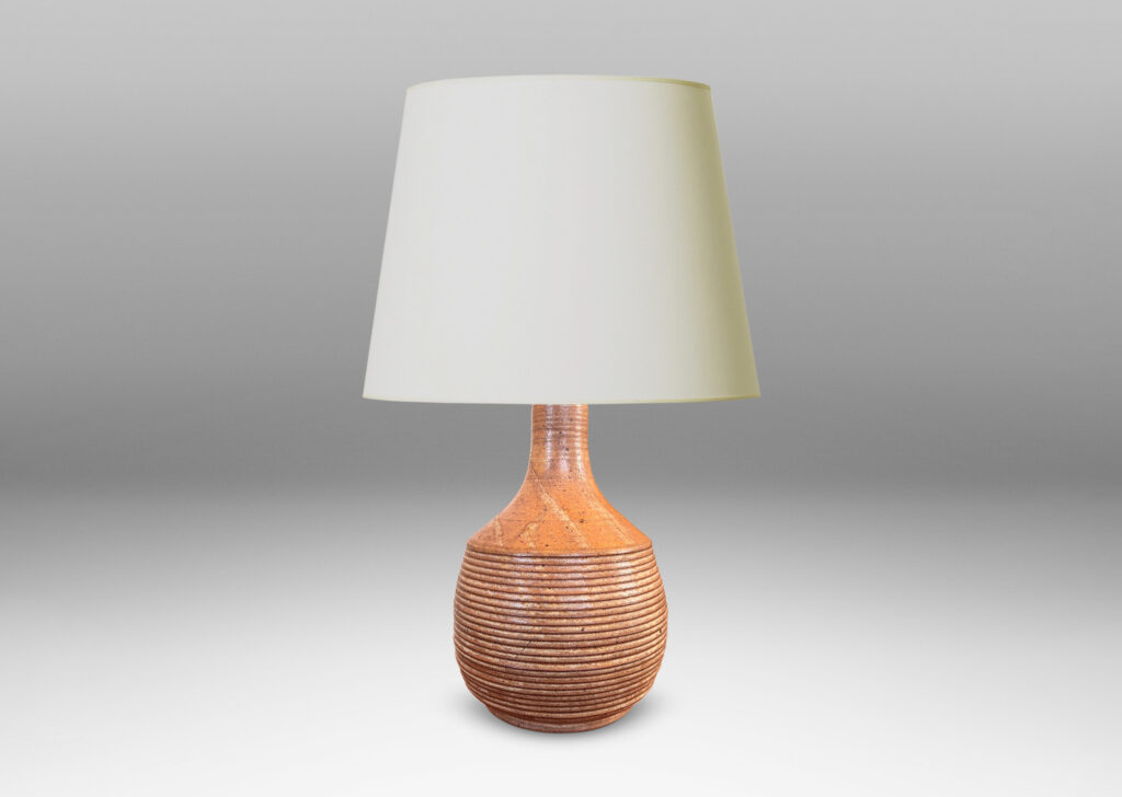 Gallery BAC jug-like form with ridged bulging body and smooth sprouting neck, glazed in light brown-pale taupe