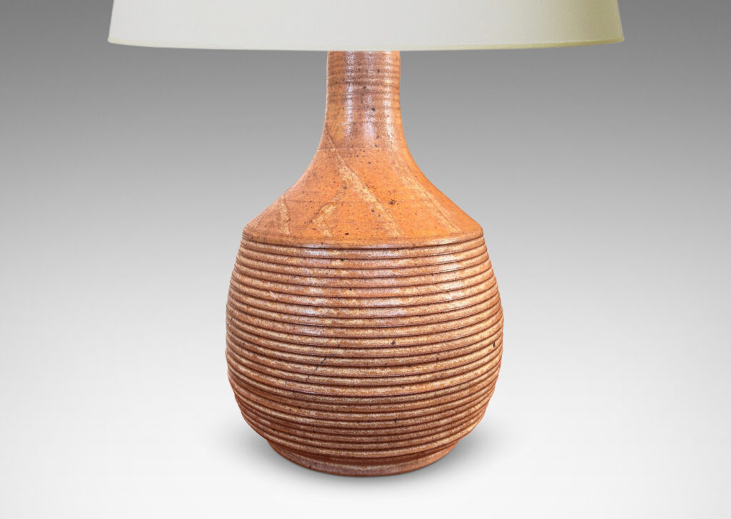 Gallery BAC jug-like form with ridged bulging body and smooth sprouting neck, glazed in light brown-pale taupe