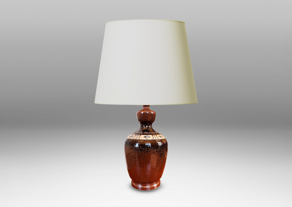 Gallery BAC urn style tapered ovoid form with textured surface with bands of carved geometric designs, glazed in brown, with ivory and gray-blue