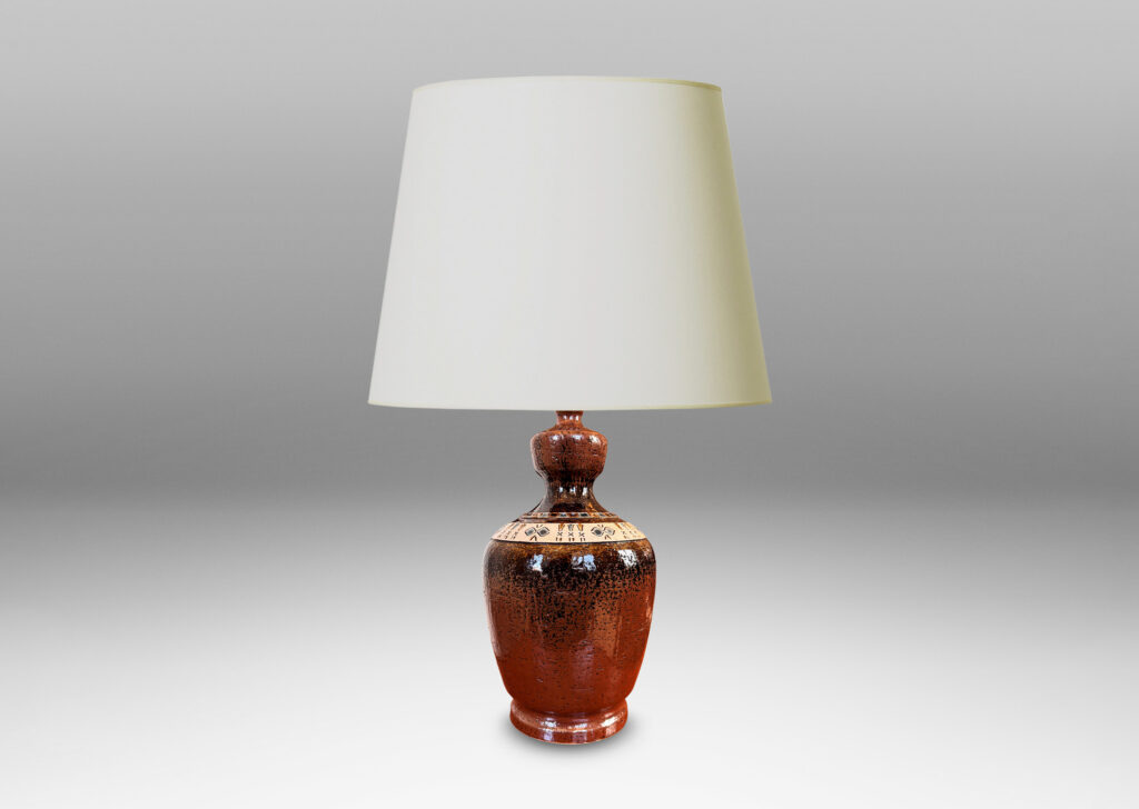 Gallery BAC urn style tapered ovoid form with textured surface with bands of carved geometric designs, glazed in brown, with ivory and gray-blue