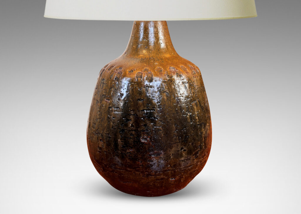 Gallery BAC plump ovoid form with grog texture and geometric motifs impressed around shoulder, glazed in olive brown