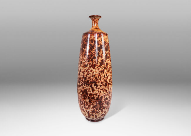 Gallery BAC all attenuated ovoid form with cove shoulders and outstretched mouth, glazed in a handsome mottled mahogany brown over pale tan