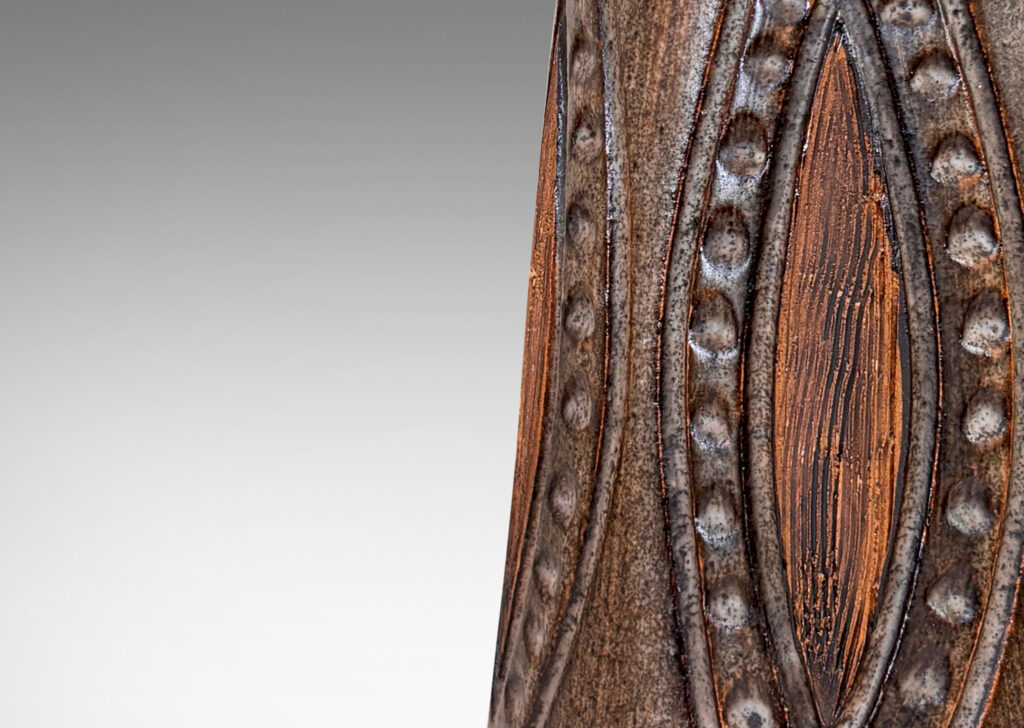 Gallery BAC cylindrical form with carved ogival pattern and raked footing, glazed in matte dark brown