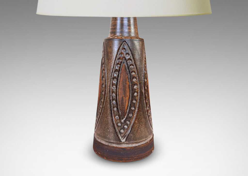 Gallery BAC cylindrical form with carved ogival pattern and raked footing, glazed in matte dark brown