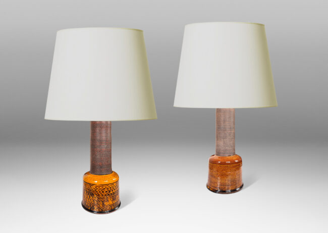 Gallery BAC bell forms ornamented with herringbone bands, and plain cylindrical necks, glazed in shiny dark honey gold and matte brown