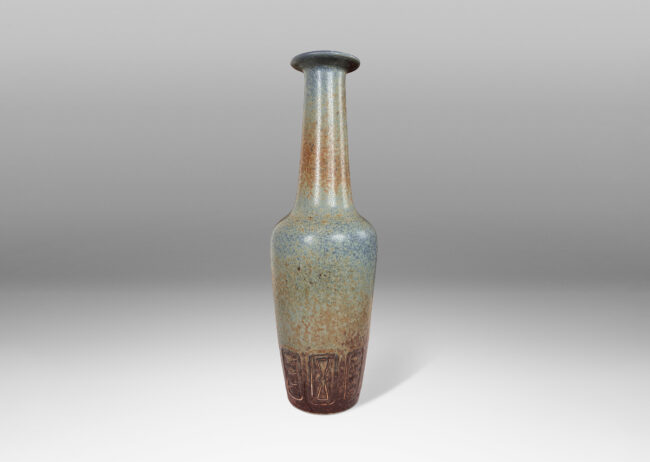 Gallery BAC large rationalized bottle form, with angled sides, impressed geometric motifs, tall neck, and flanged lip, in an eggshell finish cornflower blue-brown hare’s fur glaze