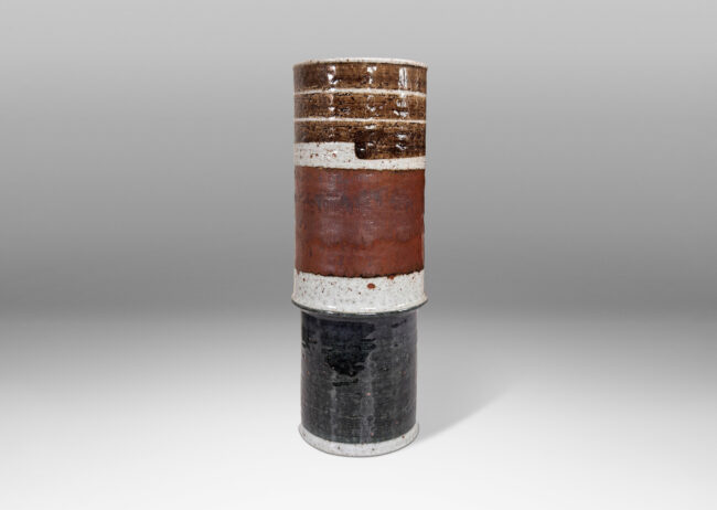 Gallery BAC tiered cylindrical forms glazed in a graphic design of black, blue-gray and luster brown over pale gray