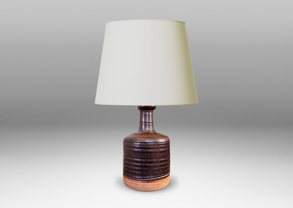 Gallery BAC idged cylindrical form with sprouting neck, partially glazed in a dark brown luster, with sgraffito ring ornament
