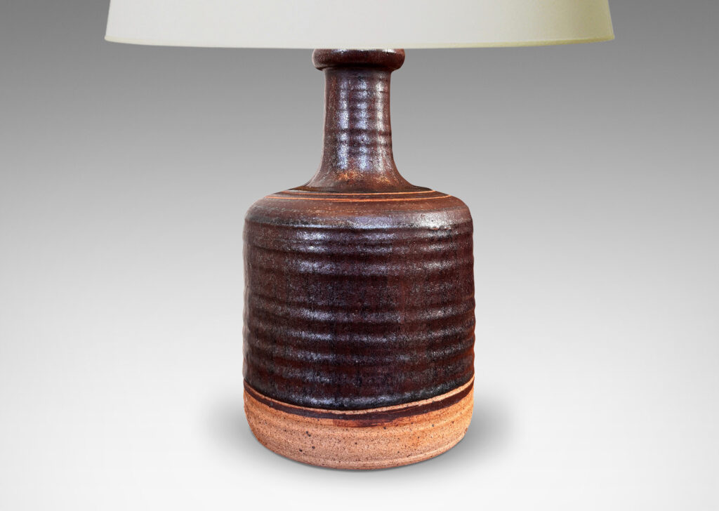 Gallery BAC idged cylindrical form with sprouting neck, partially glazed in a dark brown luster, with sgraffito ring ornament