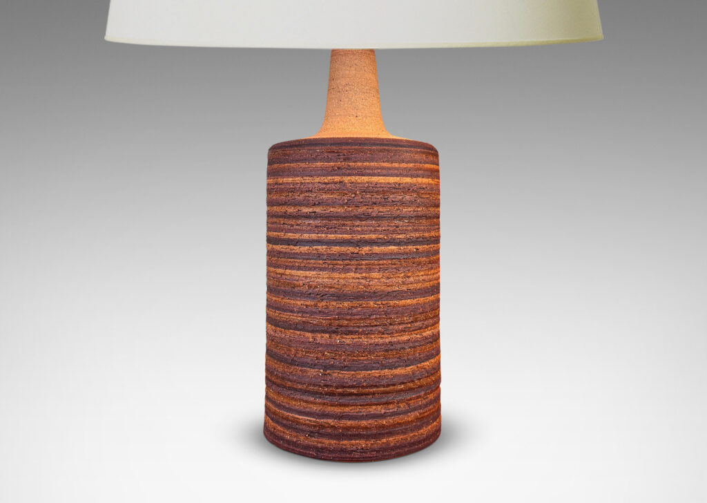 Gallery BAC cylindrical form with rustic grog texture and sprouting neck, partially glazed in matte dark brown
