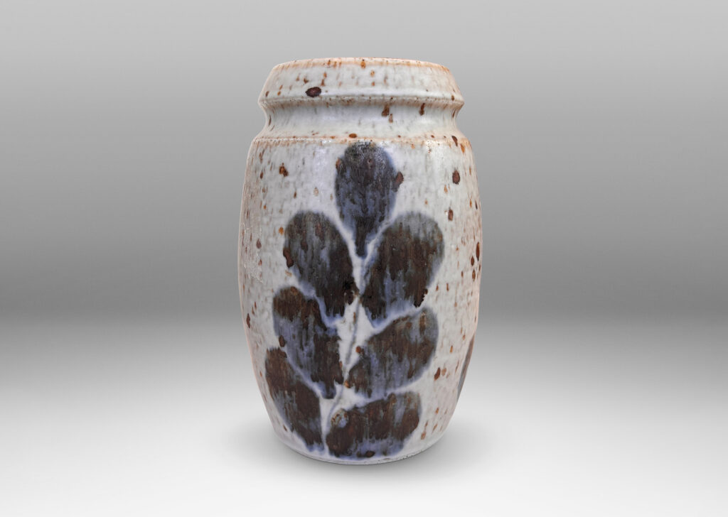 Gallery BAC swelling form and notch articulated neck, glazed in a mottled pale gray, with abstracted foliate forms in dark blue-gray