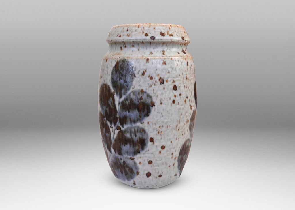 Gallery BAC swelling form and notch articulated neck, glazed in a mottled pale gray, with abstracted foliate forms in dark blue-gray