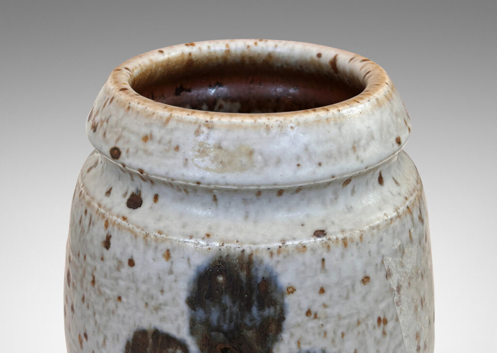 Gallery BAC swelling form and notch articulated neck, glazed in a mottled pale gray, with abstracted foliate forms in dark blue-gray