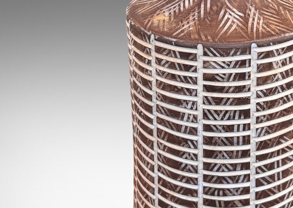 Gallery BAC cylindrical form with cove neck in matte brown ceramic, with carved grid and crosshatch texture highlighted in shiny white glaze