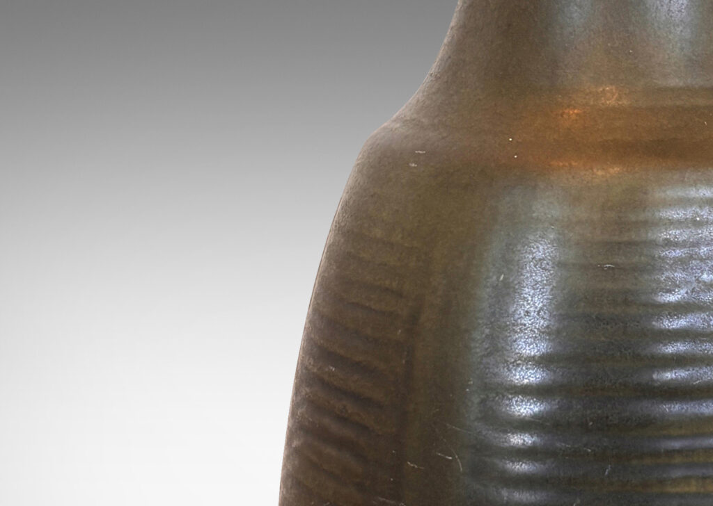 Gallery BAC pawn-like form, with relief linear designs, glazed in an eggshell dark jungle green