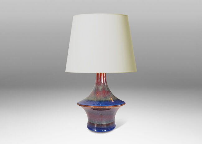 Gallery BAC wide floating disk with coved reveal and spouting neck, glazed in a lustrous blue with brown accents