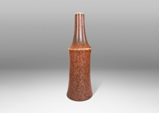 Gallery BAC cove-sided cylindrical form with sprouting neck, glazed in mottled medium and dark brown tones