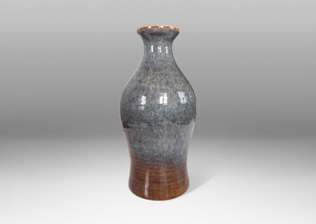 Gallery BAC swelling form with flared mouth and subtle turning ridges, glazed in glossy gray-blue and brown