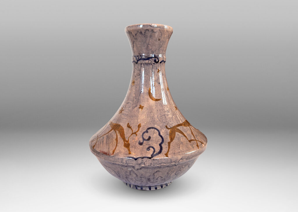 Gallery BAC decanter-like form with tall coved neck, glazed in a thin blue wash over pale rose, overpainted with deer and scrolls in blue and gold