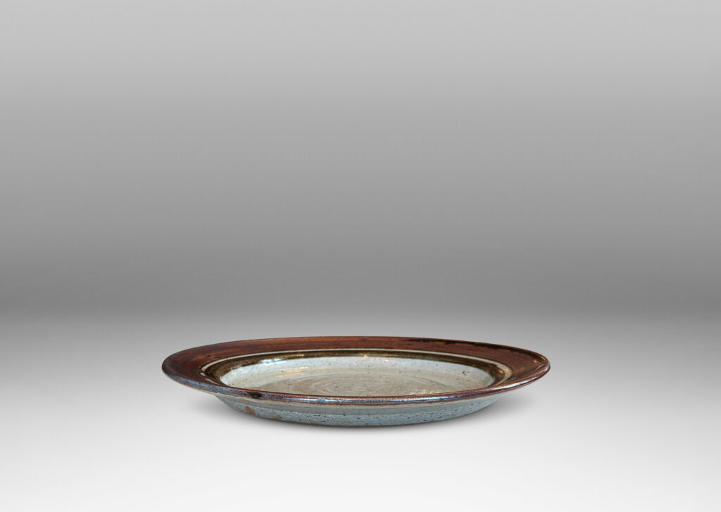 Gallery BAC glazed in dappled pal gray, with angled lip in red with black luster