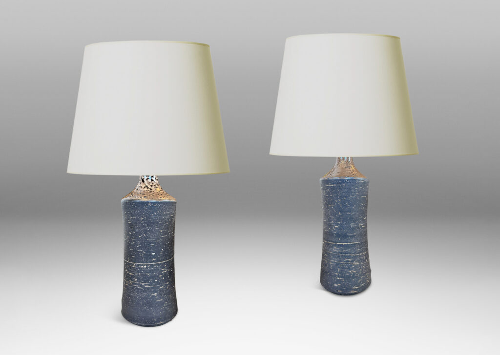 Gallery BAC concave sided cylindrical forms with grog texture and matte brown glaze, with shiny brown caps