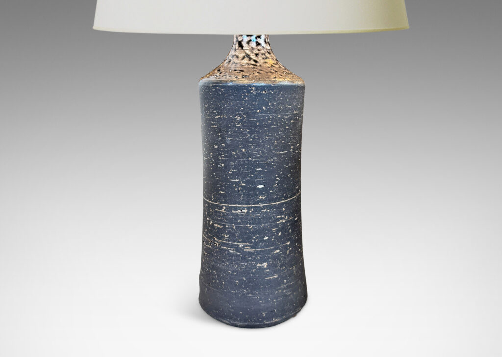 Gallery BAC concave sided cylindrical forms with grog texture and matte brown glaze, with shiny brown caps