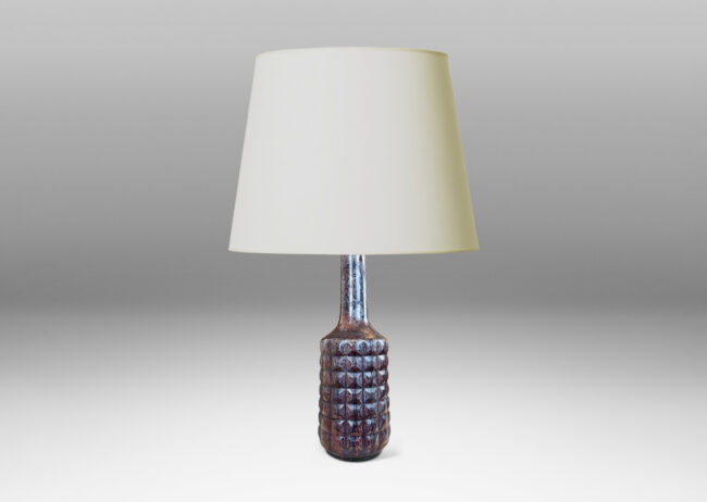 Gallery BAC bottle-like forms encircled in relief grids; glazed in oxblood red with gray luster