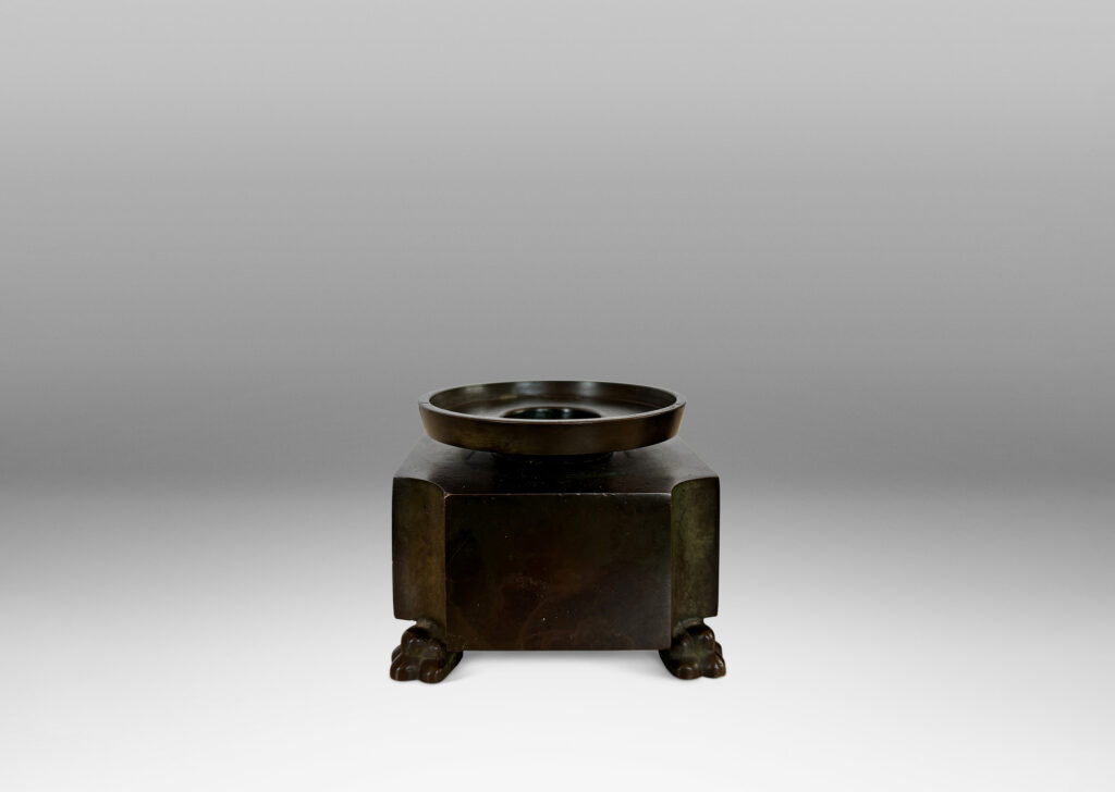 notched square bases, with floating bobèches and lion paw feet