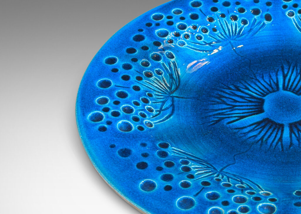 Gallery BAC wide curving lip and carved design of dill or yarrow flower umbels, glazed in a saturated shiny azure, with matte pale gray reverse