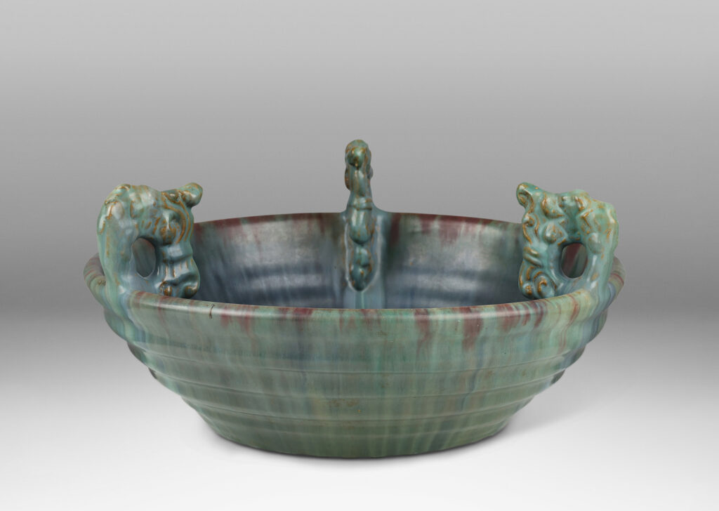 Gallery BAC stepped angled side and three high relief foliate ornaments, glazed in a flowing green