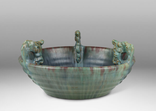 Gallery BAC stepped angled side and three high relief foliate ornaments, glazed in a flowing green