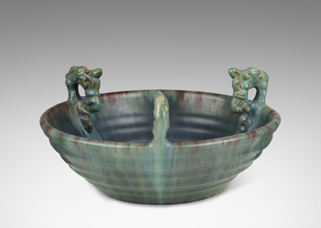 Gallery BAC stepped angled side and three high relief foliate ornaments, glazed in a flowing green