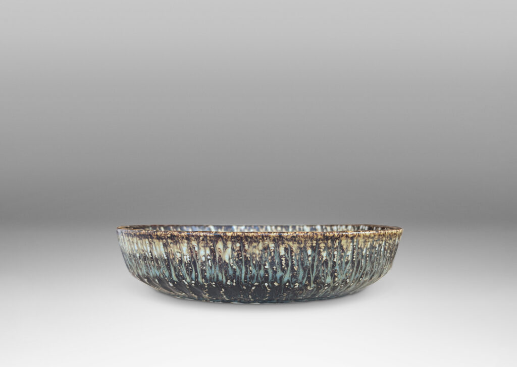 Gallery BAC clean form with angled sides, with carved surface texture and flowing brown glaze