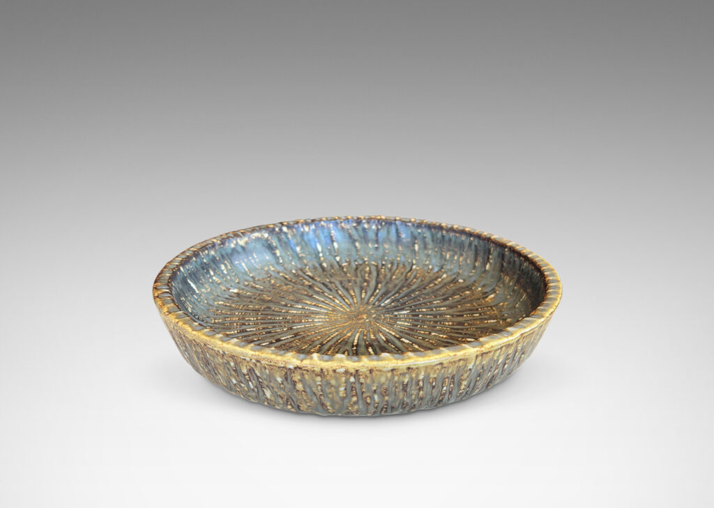 Gallery BAC clean form with angled sides, with carved surface texture and flowing brown glaze