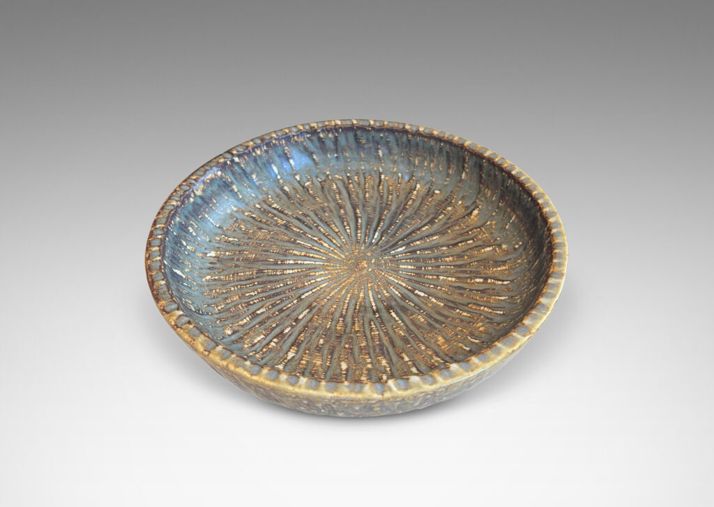 Gallery BAC clean form with angled sides, with carved surface texture and flowing brown glaze