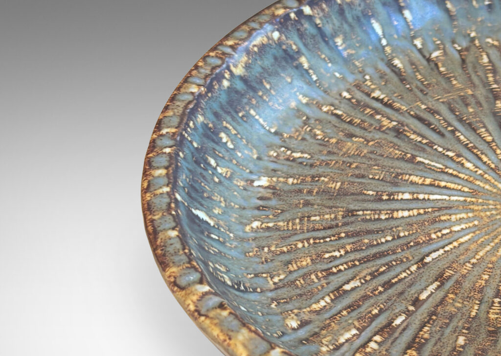 Gallery BAC clean form with angled sides, with carved surface texture and flowing brown glaze