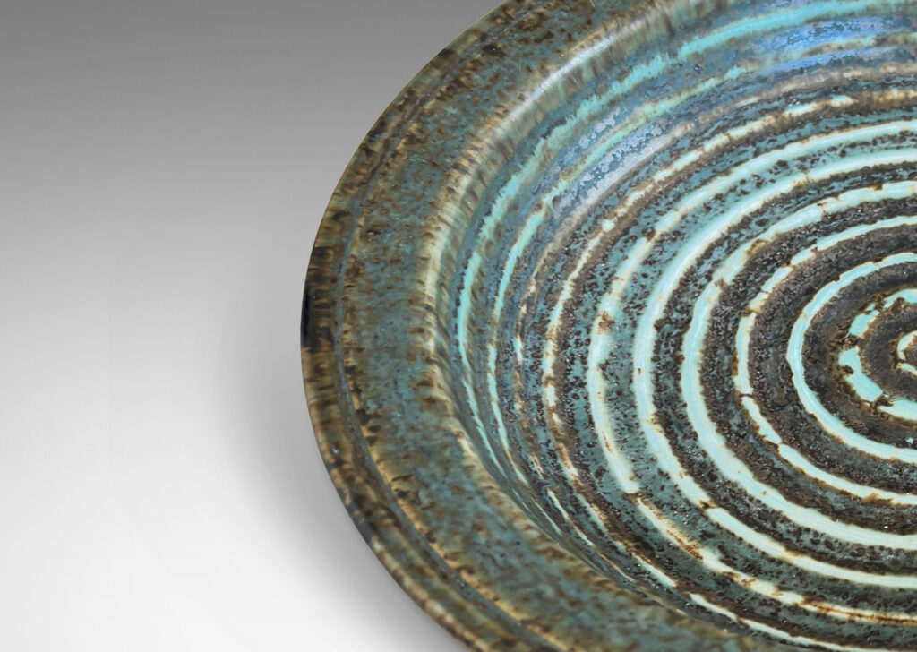 Gallery BAC flat flanged lip and relief concentric circles inside, glazed in gray-brown and pale blue