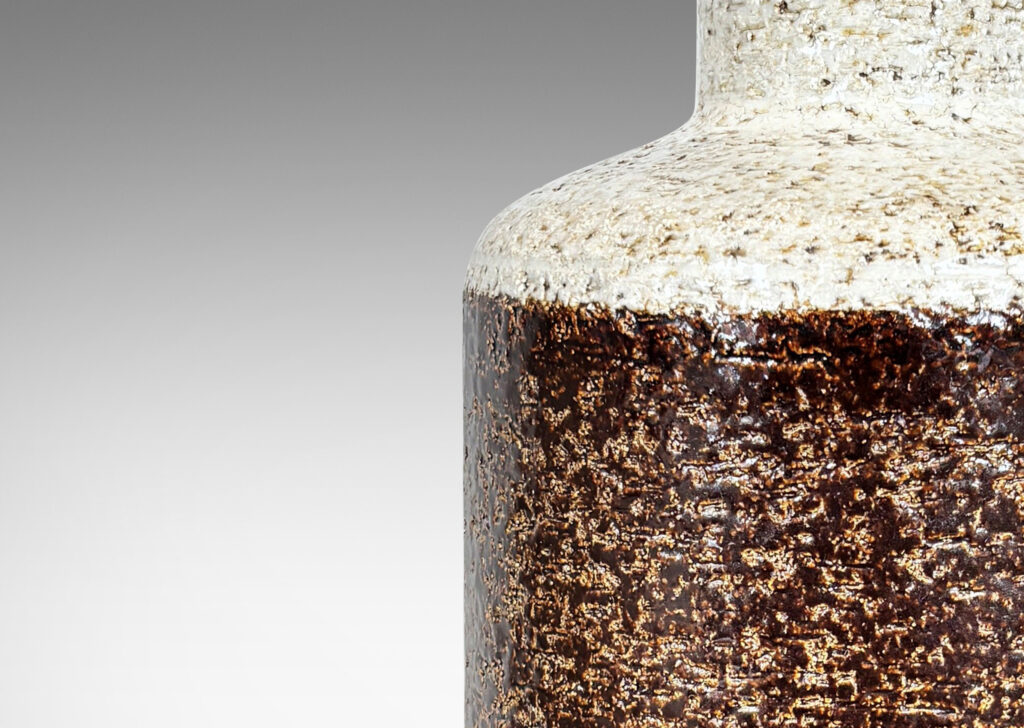 Gallery BAC textured canister forms, with cylindrical bodies, wide necks and flange tops, glazed in brown and white