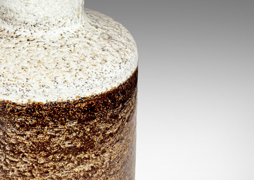 Gallery BAC textured canister forms, with cylindrical bodies, wide necks and flange tops, glazed in brown and white