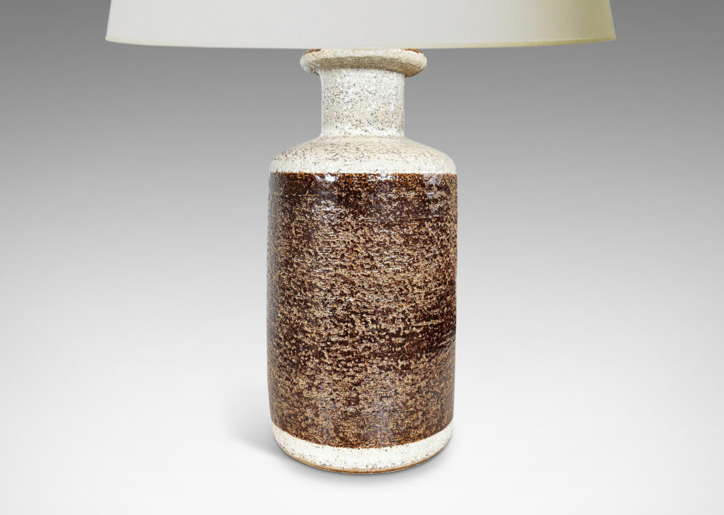 Gallery BAC textured canister forms, with cylindrical bodies, wide necks and flange tops, glazed in brown and white