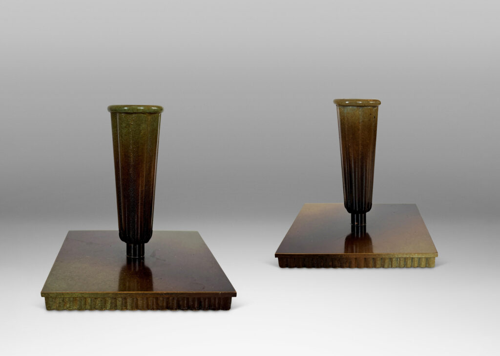 Gallery BAC fluted trumpet sockets and square base over a scalloped reveals, finished with a handsome enameled verdigris-antique patination