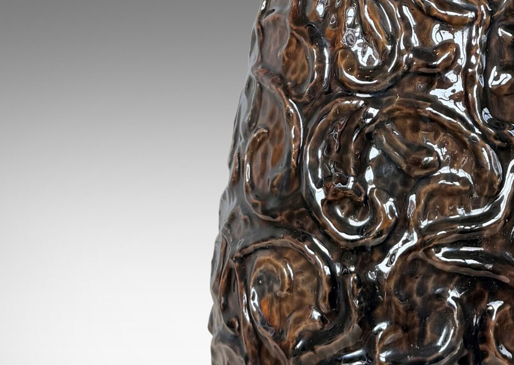 Gallery BAC large drop form with scrolling reliefs and carved gouged texture, glazed in a shiny dark brown